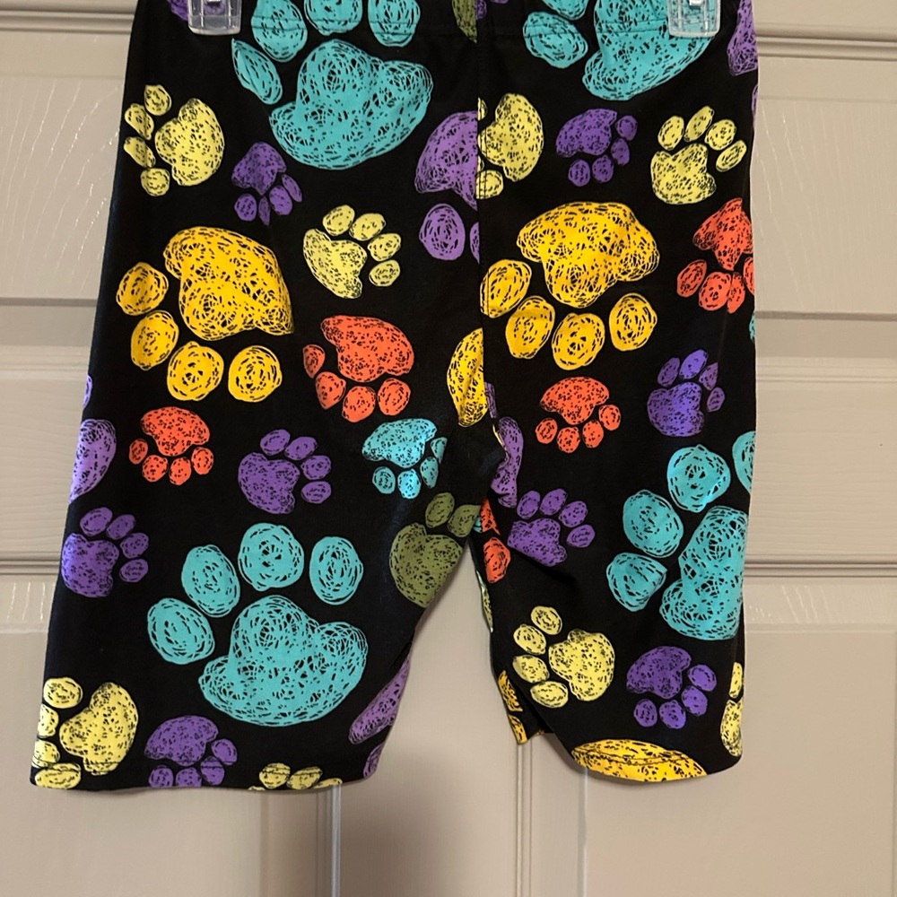 Black and Yellow Bike Shorts with Vibrant Paw Prints